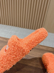 FURRY SLIDES IN ORANGE CURLY SHEARLING