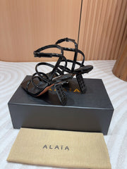 ALAIA THREE-STRAPS HIGH HEEL SANDALS IN BLACK PATENT LAMBSKIN