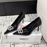 POINTED HIGH PUMPS IN BLACK PATENT CALFSKIN WITH CRYSTAL BUCKLE
