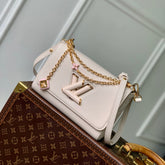 TWIST SLIM 19 IN LIGHT PINK TAURILLON CALFSKIN GOLD HARDWARE