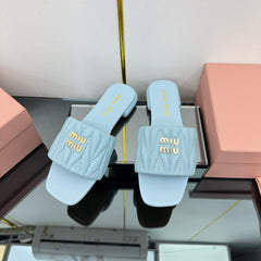 MATELASSÉ SLIDES IN BABY BLUE CALFSKIN