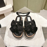 CC SLIPPERS WITH SILK BOW IN BLACK COWHIDE