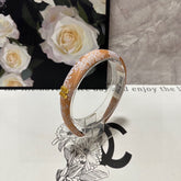 HEADBAND WITH GARNITURE PRINT IN TIGER EYE ORANGE SILK 432822