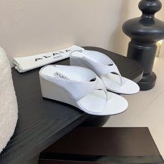 ALAIA WEDGE THONG SANDALS 25S IN WHITE SATIN