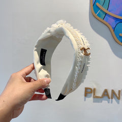 WHITE FABRIC WITH GOLD LOGO HAIRBAND 410841