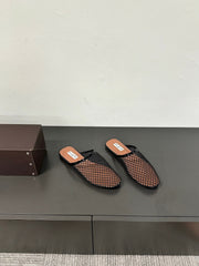 ALAIA FLAT MULES IN BLACK MESH FISHNET