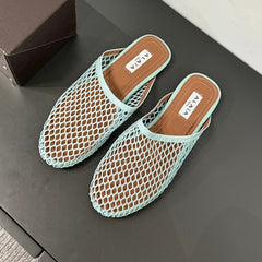 ALAIA FLAT MULES IN LIGHT BLUE MESH FISHNET