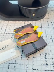 ALAIA FLAT SLINGBACK IN YELLOW PATENT CALFSKIN AND FILM