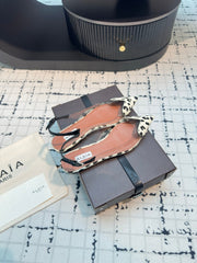 ALAIA FLAT SLINGBACK IN BLACK MIX WHITE PATENT CALFSKIN AND FILM