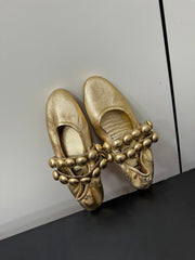 ALAIA SPHERE BALLET FLATS IN GOLDEN LAMBSKIN