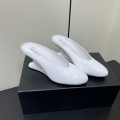 ALAIA WEDGE MULES 25S IN CREAM WHITE LAMBSKIN