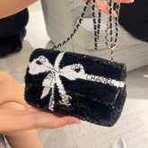 CHANEL 25S FLAP BAG 20 CM IN BLACK SEQUINS WITH WHITE BOW