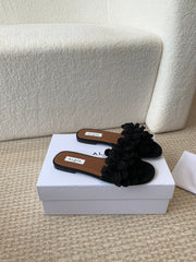 ALAIA FLAT MULE IN BLACK SUEDE