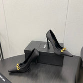 HIGH PUMPS IN BLACK SILK ATTACHED GOLD CHAIN