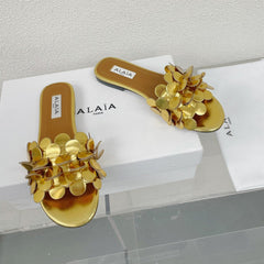 ALAIA FLAT MULE IN GOLDEN GLOSSY LAMBSKIN