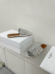 ALAIA VIENNE FLAT MULES IN SILVER LAMBSKIN