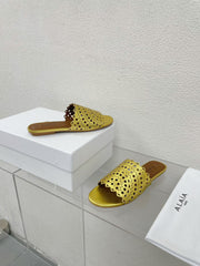 ALAIA VIENNE FLAT MULES IN GOLDEN LAMBSKIN