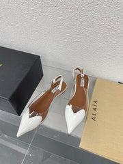 ALAIA LE COEUR FLAT SLINGBACKS IN WHITE PATENT LAMBSKIN