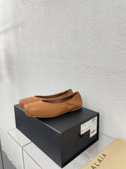 ALAIA BALLET FLATS IN COPPER BROWN CALFSKIN