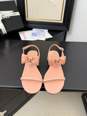 FLAT SANDALS IN PEACHY PINK CALFSKIN WITH BOW