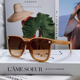 TRIOMPHE SUNGLASSES 552774 IN CARAMEL ACETATE TEXT LOGO