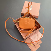 MICRO BAG KEYCHAIN 11 IN HOT CINNAMON ORANGE CALFSKIN EMBOSSED LOGO