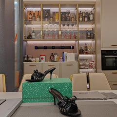 BOW-EMBELLISHED HIGH MULES IN BLACK SHEEPSKIN