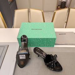 BOW-EMBELLISHED HIGH MULES IN BLACK SHEEPSKIN