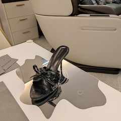 BOW-EMBELLISHED HIGH MULES IN BLACK SHEEPSKIN