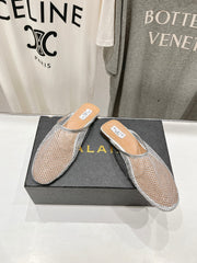 ALAIA FLAT MULES IN SILVER MESH FISHNET