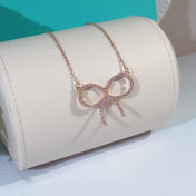 CLAW SET RHODIUM PLATED BOW NECKLACE