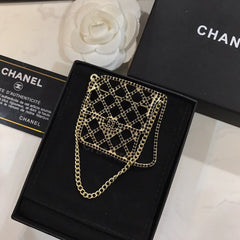 BAG SHAPED BROOCH IN GOLD METAL WITH BLACK CRYSTAL