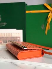 MONTE-CARLO PM CLUTCH 25 IN ORANGE GOYARDINE CANVAS