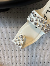 ALAIA FOLDED FLAT MULES WITH SPHERES ON WHITE CALFSKIN
