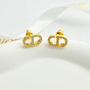 CD 26S CRYSTAL LOGO STUD EARRINGS IN GOLD METAL 633106