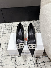 POINTED HIGH PUMPS IN BLACK PATENT CALFSKIN WITH CRYSTAL BUCKLE