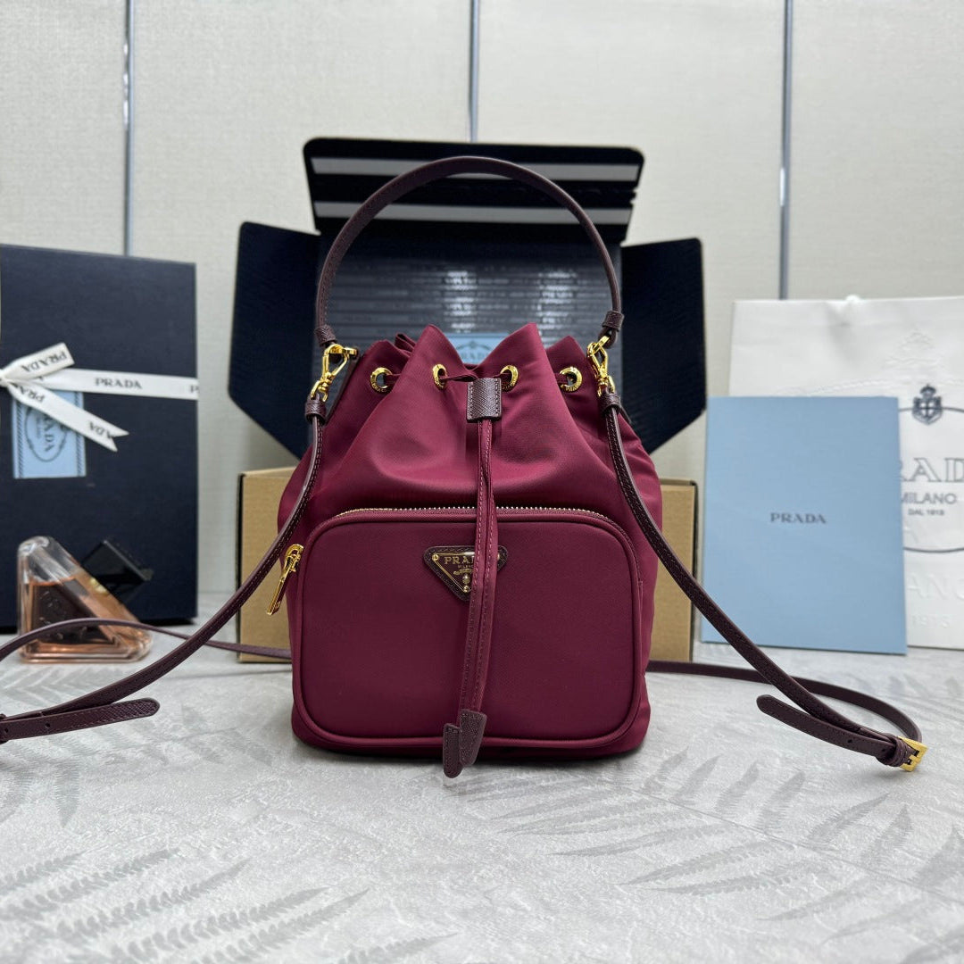 PRADA 25S DUET BUCKET BAG 23 IN BURGUNDY RE-NYLON GOLD HARDWARE