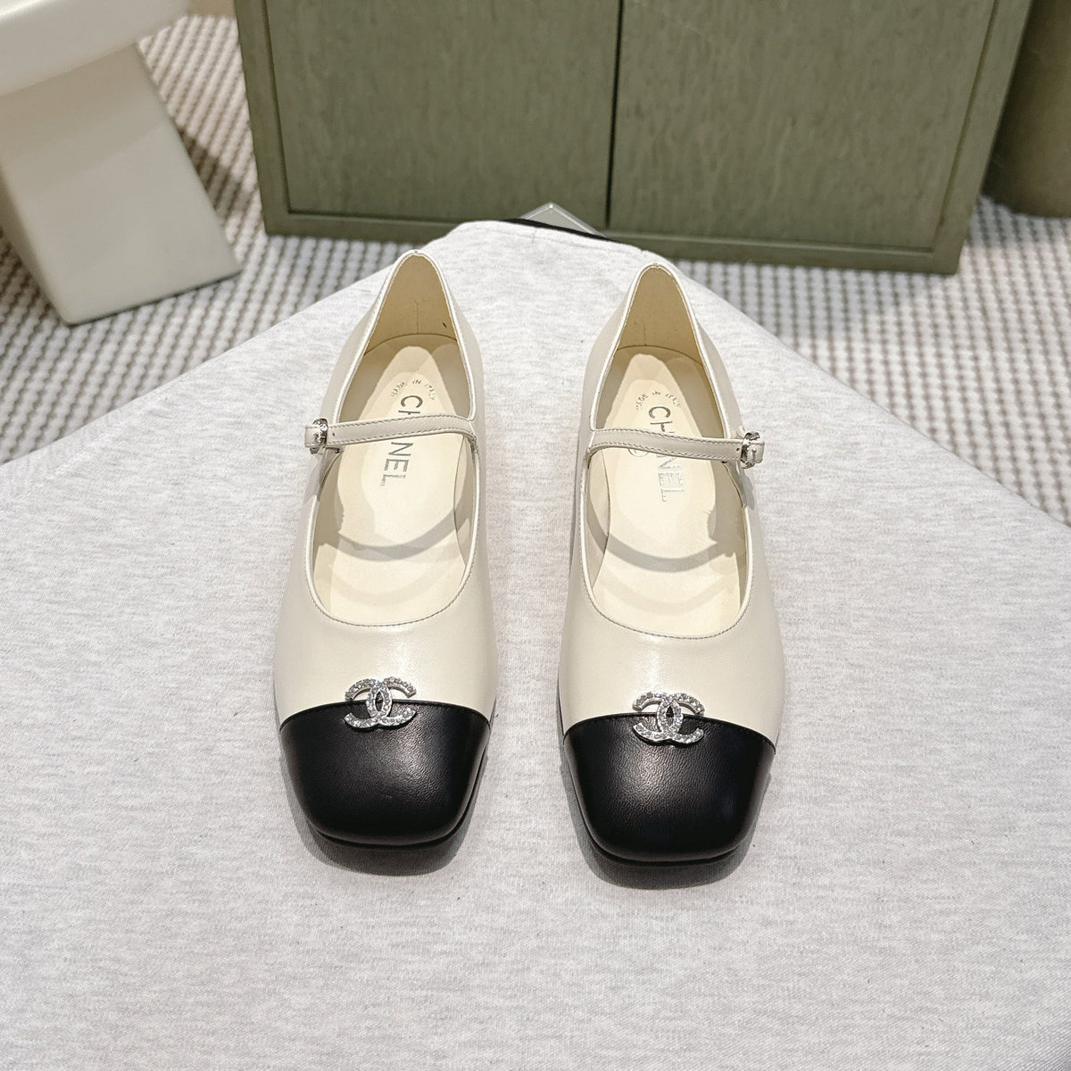 CHANEL 25S MARY JANE FLATS IN IVORY LAMBSKIN WITH BLACK CAP TOE SILVER HARDWARE