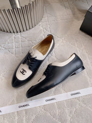 CHANEL 25S TWO TONE LACE UP IN BLACK AND WHITE CALFSKIN