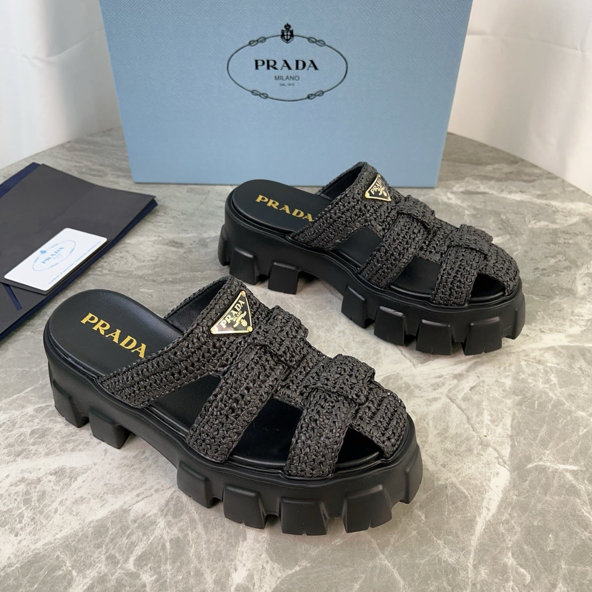 PRADA 25S MONOLITH RUBBER MULES IN BLACK RAFFIA AND LAMBSKIN