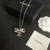 CHANEL 26S DOUBLE C LOGO CLEAR BOW PENDANT NECKLACE IN GOLD METAL 629174