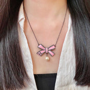 CHANEL 26S DOUBLE C LOGO PINK ENAMEL BOW & PEARL PENDANT NECKLACE IN BLACK METAL 629976