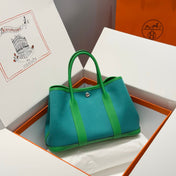 GARDEN PARTY 30CM IN CADMIUM GREEN TOILETS COTTON CANVAS AND GREEN CALFSKIN