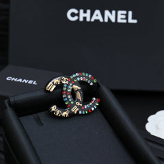 DOUBLE C BROOCH IN HAND-PAINTED ACRYLIC RESIN WITH COLORFUL STONE DESIGN
