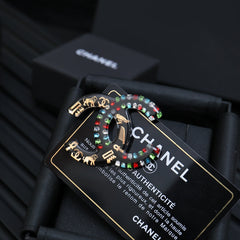 DOUBLE C BROOCH IN HAND-PAINTED ACRYLIC RESIN WITH COLORFUL STONE DESIGN