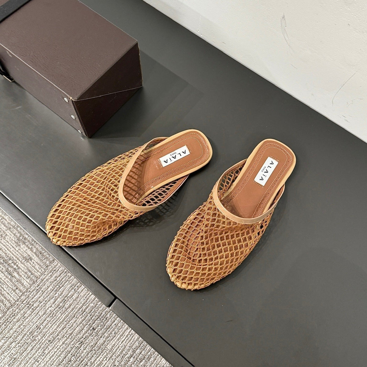 ALAIA FLAT MULES IN COPPER BROWN MESH FISHNET