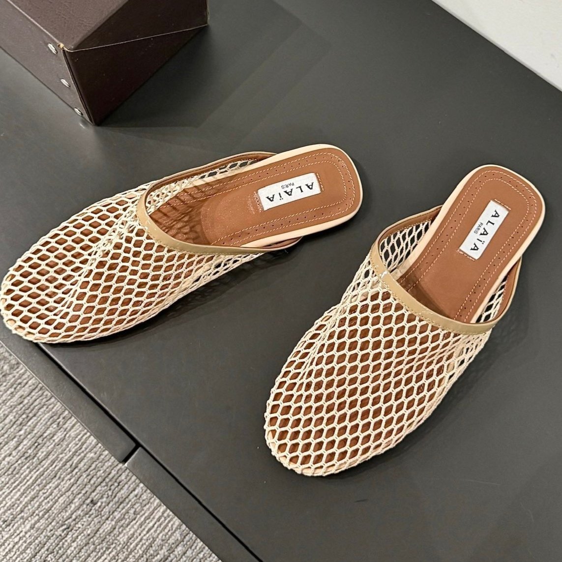ALAIA FLAT MULES IN BEIGE MESH FISHNET