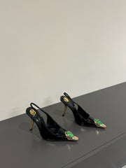 GREEN GEM-STUDDED SLINGBACK PUMPS IN BLACK PATENT CALFSKIN