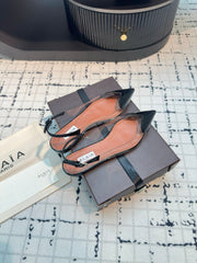 ALAIA FLAT SLINGBACK IN BLACK PATENT CALFSKIN AND FILM