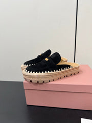 MULES SLIPPERS IN BLACK SUEDE WITH GOLD COIN